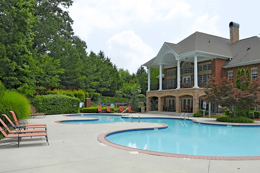 a large swimming pool in front of a house