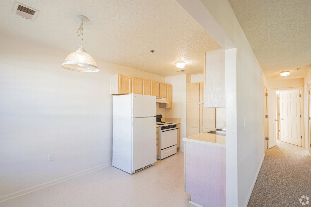 a renovated kitchen with white appliances and white cabinets