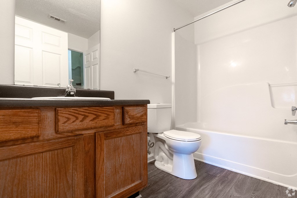 an empty bathroom with a toilet and a sink at Pendleton Townhomes Apartments, Durham