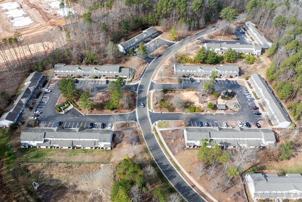 an aerial view of a neighborhood of houses and a road at Pendleton Townhomes Apartments, Durham, NC