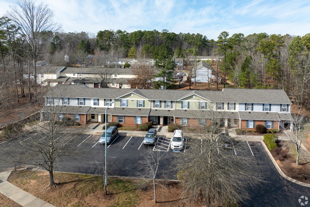 an aerial view of a building with cars parked in a parking lot at Pendleton Townhomes Apartments, Durham, 27703