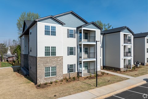 A row of modern townhouses with balconies and garages at Dunean Creek Apartments, Greenville, 29611