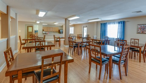 A dining room with wooden chairs and tables.