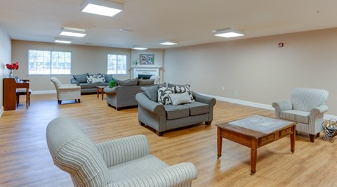 A living room with a grey couch and a wooden coffee table.