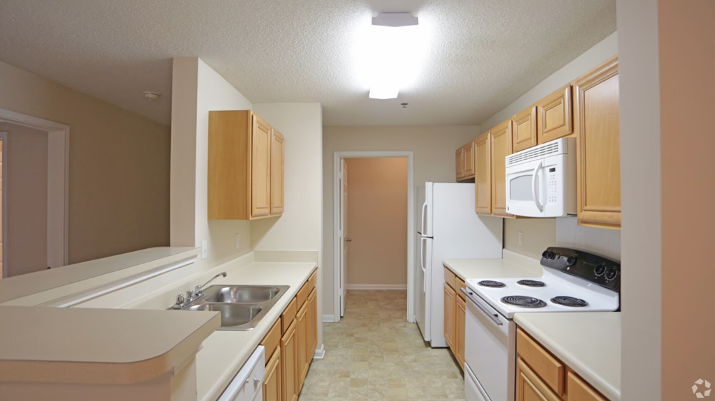 a kitchen with white appliances and wooden cabinets