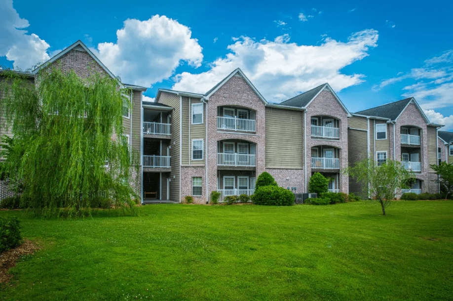 an apartment building with a green lawn
