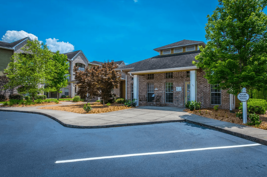 a driveway in front of a house with a parking lot