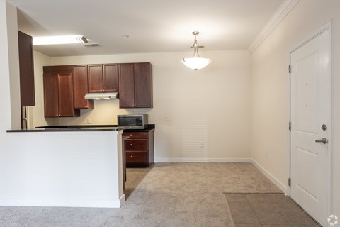 A kitchen with brown cabinets and a white counter.