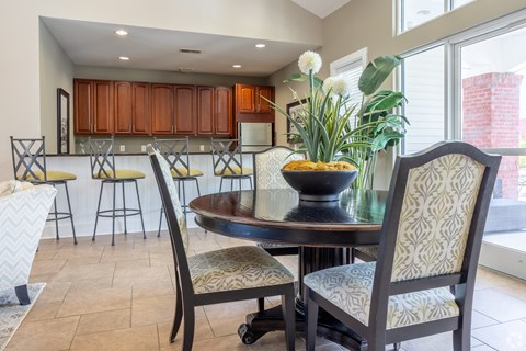 A dining room with a table and chairs.