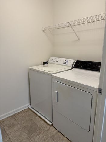 A white oven and microwave in a small kitchen.