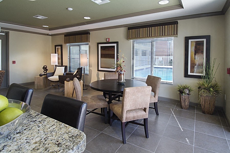 a dining room and living room with a table and chairs