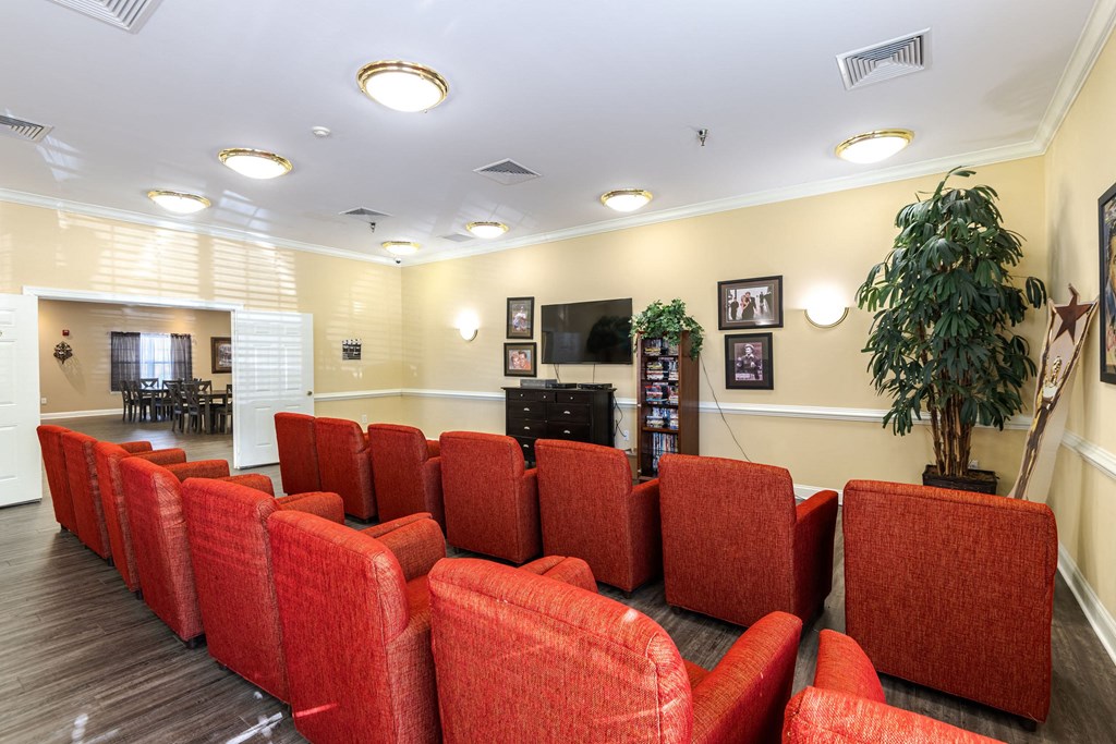 A row of red chairs are lined up in a room.at The Gardens of Stafford, Stafford, VA 22556  