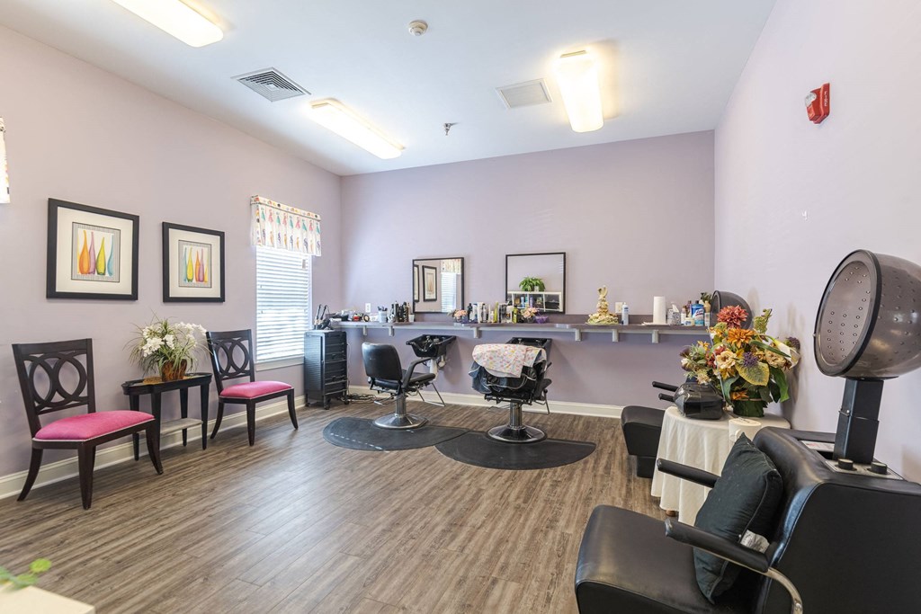 A hair salon with chairs and a mirror.at The Gardens of Stafford, Stafford, Virginia  