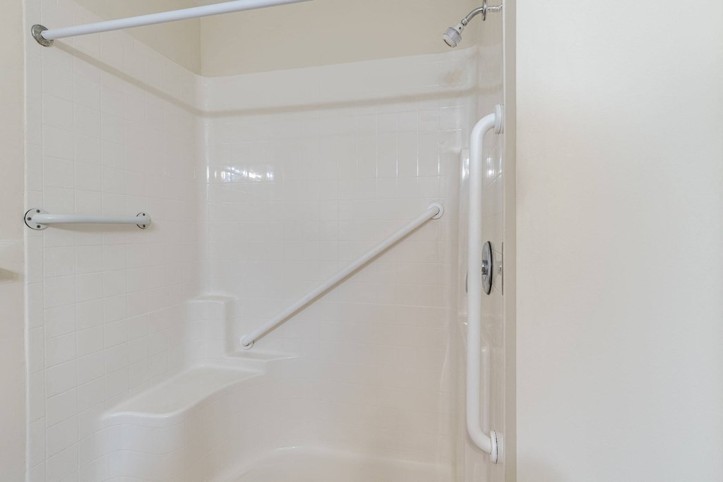 A white bathroom with a walk in shower.at The Gardens of Stafford, Stafford, Virginia  
