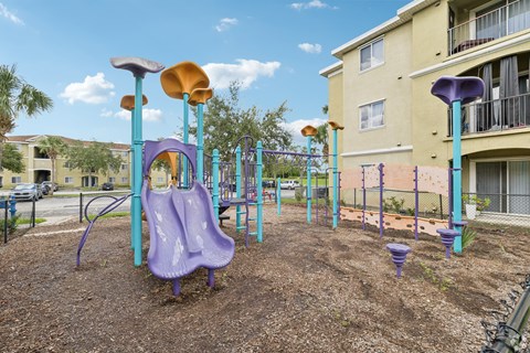 A playground with a purple slide and a yellow slide.