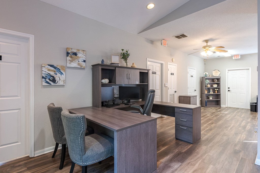A room with a desk and chairs.at The Village at England Run, Fredericksburg, VA  