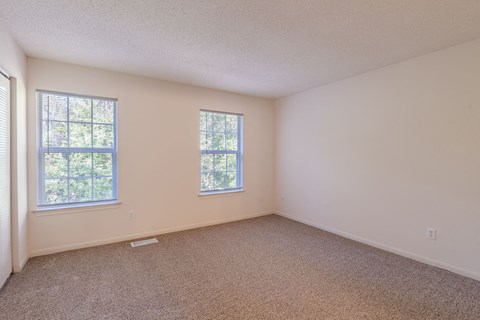 A room with two windows and carpeted floor.at The Village at England Run, 22406