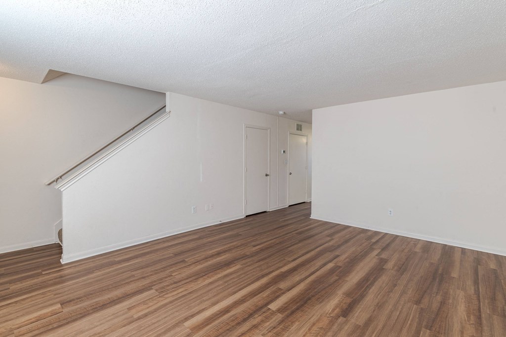 A room with wooden flooring and white walls.at The Village at England Run, Virginia  