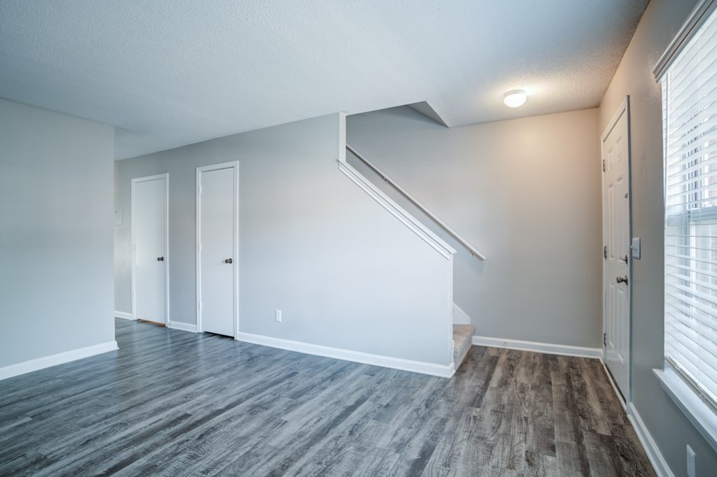 A room with a staircase and a window.