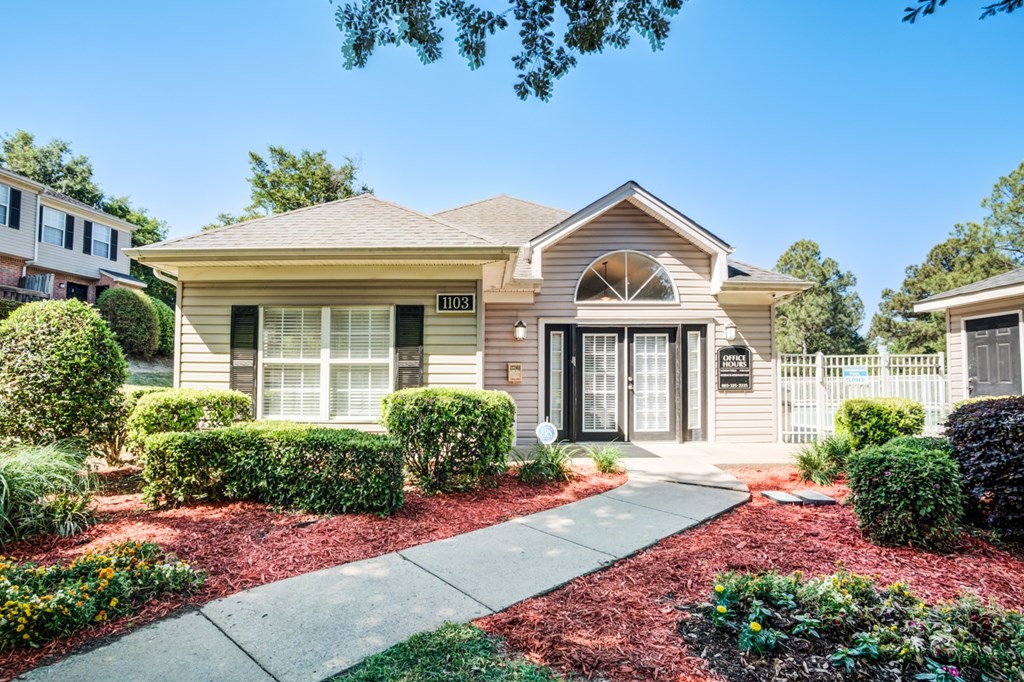 A house with a front yard and a driveway.