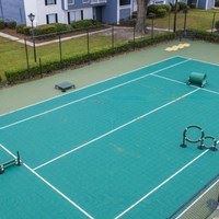 A tennis court with a green surface and white lines.