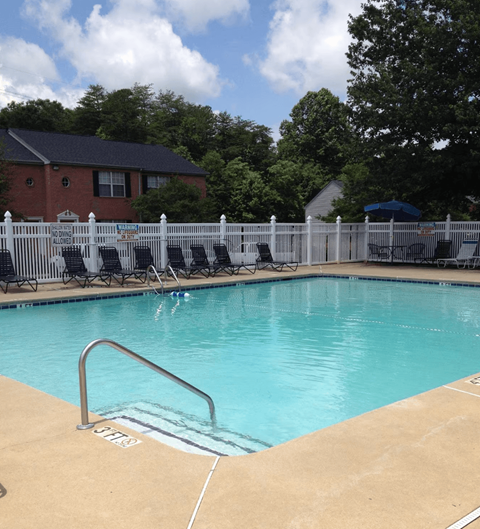 a resort style pool with chairs and a fence around it at Brookside Pointe, Travelers Rest, 29690