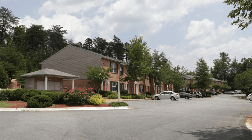 a street view of a building with cars parked in front of it