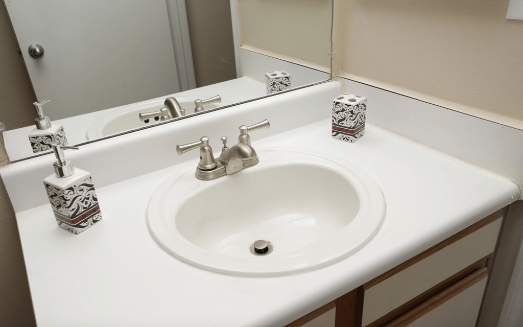 a bathroom with a sink and a mirror