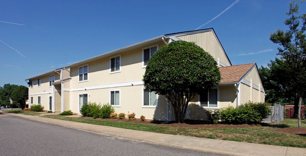 a large house with a tree in front of it