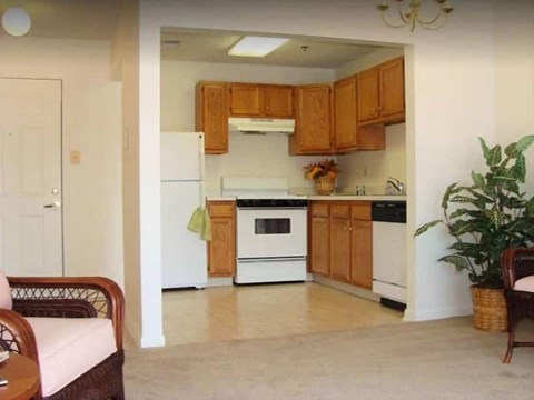 A kitchen with wooden cabinets and a white refrigerator.