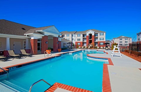 A swimming pool surrounded by a red brick border.