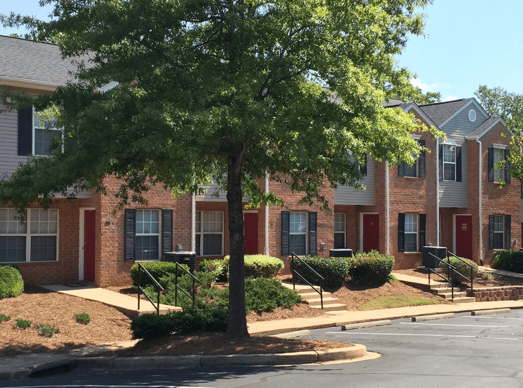 a tree in front of a brick apartment building at Canaan Pointe, Greenville South Carolina