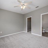 A room with a ceiling fan and a light fixture.