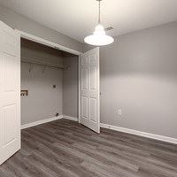A room with a grey floor and a white door.
