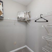 A white closet with a hanger on the right side.