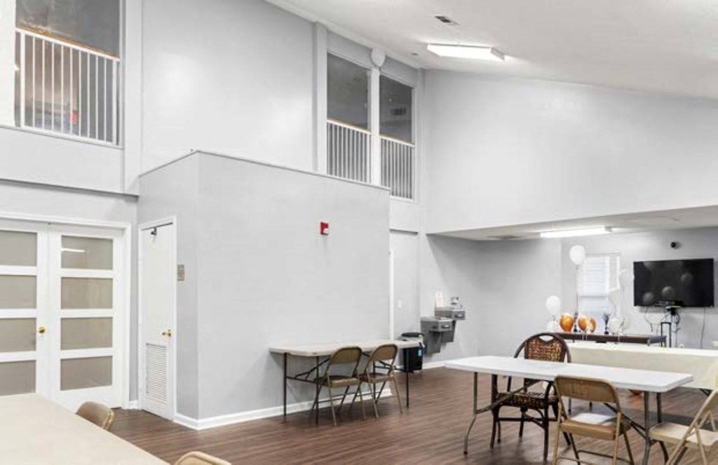 an empty living room with a table and chairs
