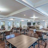 A large conference room with a long table and chairs.
