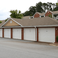 A brown house with white garage doors.