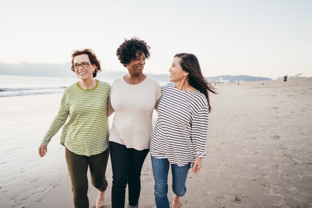 three women walking on the beach