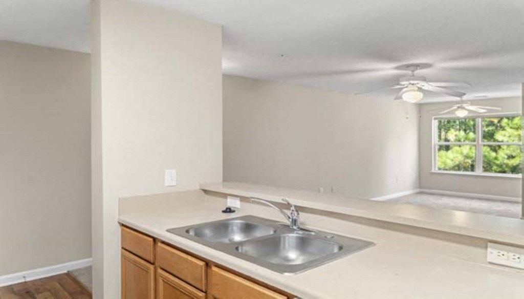 an empty kitchen with a sink and a window