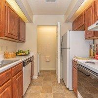 A kitchen with wooden cabinets and white appliances.