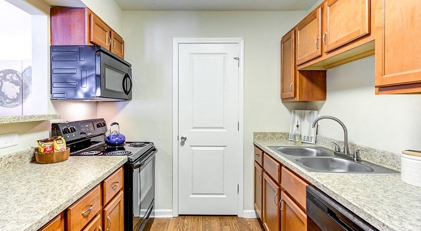 a kitchen with wood cabinets and granite countertops