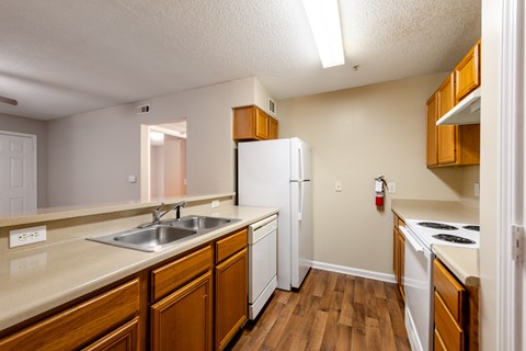 A kitchen with wooden cabinets and a white refrigerator.