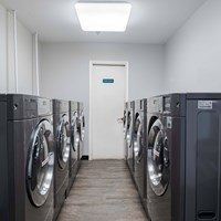 A row of washing machines in a laundromat.