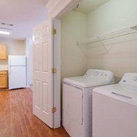 A white washer and dryer are in a small room.