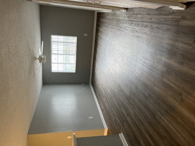 an empty room with a door and a window