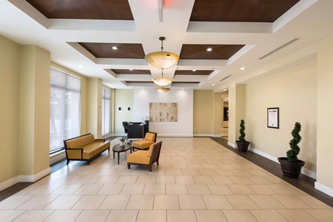 A spacious living room with a large sofa set and a television.