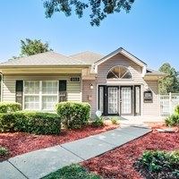 A house with a grey roof and a white door.