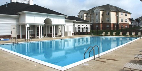 A large swimming pool in front of a building.