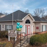 A house with a sign that says "Canavan Pointe" in front of it.
